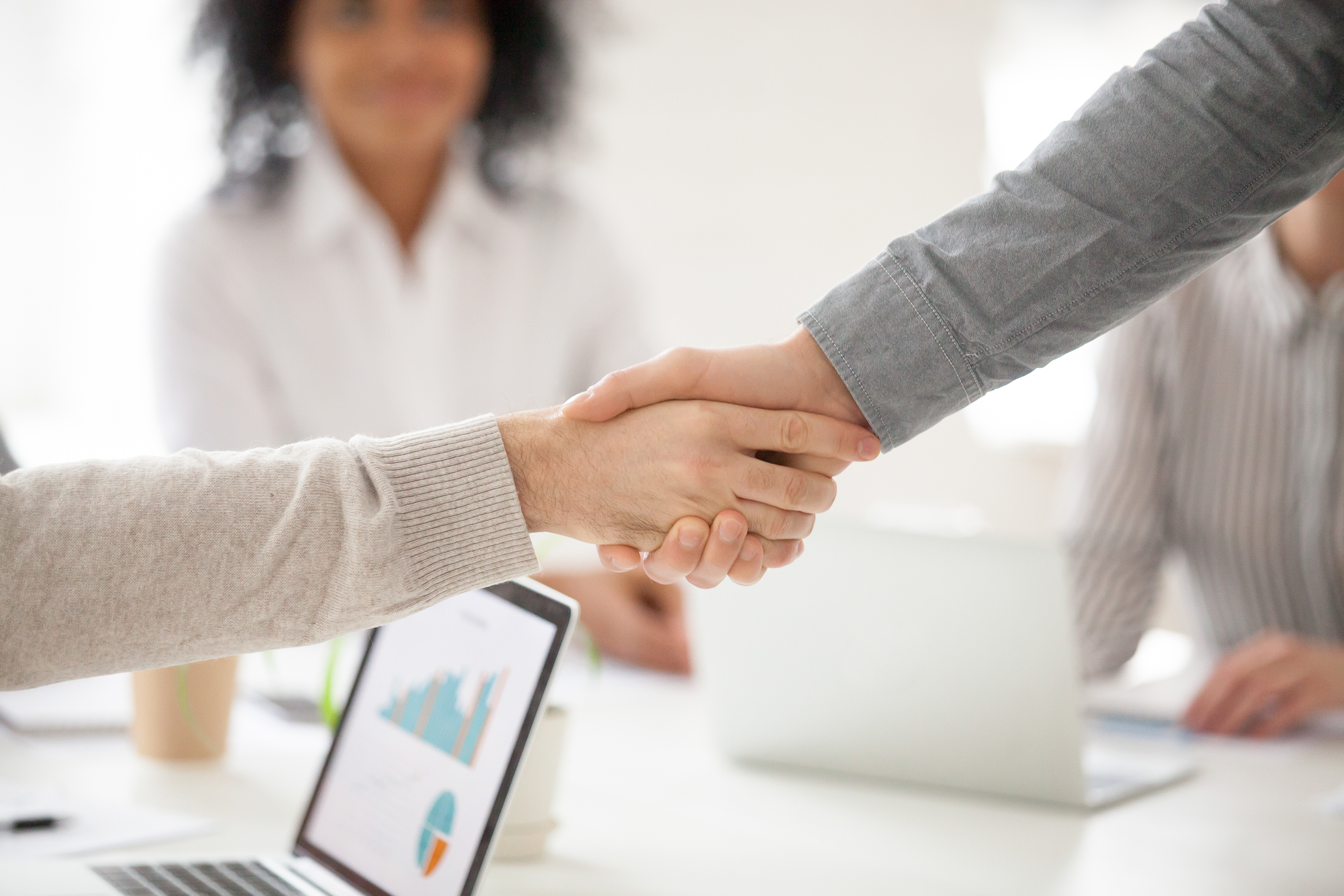 business-partners-handshaking-at-group-meeting-making-project-investment-closeup